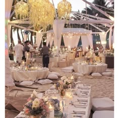 the tables are set up with white linens and candles for an outdoor wedding reception