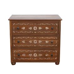 Inspired by the rich tradition of Damascene inlay. Our Damascus custom-designed nightstands are reconstructed from reclaimed wood and adorned with genuine sea mother-of-pearl. this Inlay nightstand features an elegant floral and leaf pattern, echoing the artistry of ancient eras. Damascene inlay, a centuries-old practice, once incorporated exotic materials reflecting the city's status as a major trade route. Today, shimmering mother-of-pearl takes center stage, adding a touch of luxury. Inlay Nightstand, Medallion Cabinets, Green Nightstands, Inlay Furniture, Lane Furniture, Mother Of Pearl Inlay, Iron Ring, Pearl Inlay, Ring Handle