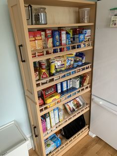 an organized pantry in the corner of a kitchen