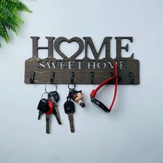 there is a key holder with some keys on it and the words home sweet home