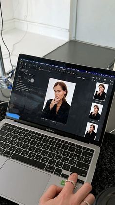 a person is using a laptop computer on a table with other items in the background