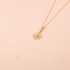 Our 14K Gold Daisy Necklace is a delightful tribute to the simplicity and beauty of nature. This captivating piece features a daisy pendant, approximately 11mm by 11mm, with white enamel petals that create an eye-catching contrast with the gold setting. The bale of the pendant is tastefully adorned with a zircon stone, adding just the right amount of sparkle. Available in your choice of Gold, Rose Gold, or White Gold, this necklace is versatile enough to complement any outfit, from casual to for White Flower Pendant Necklace With Birth Flower, White Flower Charm Pendant Necklace, White Pendant Necklace With Flower Charm, White Pendant Flower Necklace With Charm, White Birth Flower Pendant Necklace, Delicate White Flower Charm Necklaces, White Flower Charm Pendant Jewelry, White Dainty Flower Pendant Necklace, Dainty White Flower Pendant Necklace