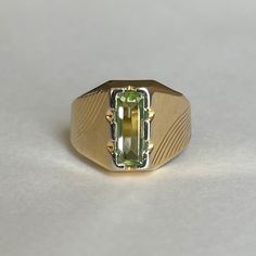 Mid Century Italian 18K Green Spinel Ring, Size 5.5, 3.5grams Size: 5.5 Weight: 3.5 grams Stone: Green Spinel Size Stone: ca. 10mm x 4mm   Number of Gemstones: 1 Cut: Emerald Bandwidth: ca 3.2mm at smallest point Markings:  Condition: Good preowned,  usage throughout -refer to pictures for condition.  All jewelry will be professionally cleaned before shipping and come in a beautiful little gift box. Returns accepted but are subjected to a 8% restock fee. Returns are only accepted for national orders. Formal Gold Sapphire Ring For May Birthstone, 14k Gold Green Ring With Polished Finish, Formal Green Sapphire Ring With Vvs Clarity, Luxury Green 14k Gold Signet Ring, Rectangular Green 14k Gold Ring, Green Rectangular 14k Gold Ring, 14k Gold Green Rectangular Ring, Luxury Green Hallmarked Signet Ring, Heirloom Yellow Gold Emerald Ring With Polished Finish