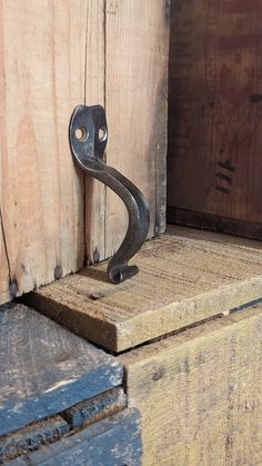 an old metal handle on the side of a wooden door