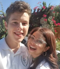 a young man and woman are smiling for the camera