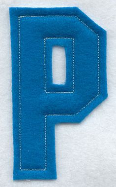 the letter p is made out of felt and stitched with blue thread on white fabric