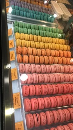 a display case filled with lots of colorful macaroons