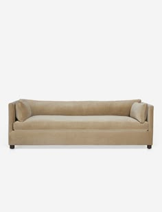 a beige couch sitting on top of a white floor