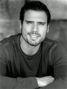 a black and white photo of a man with his arms crossed