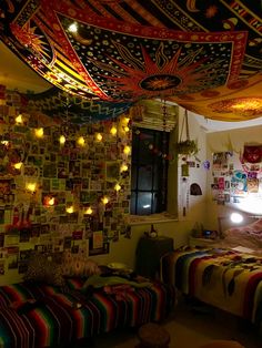 a bed room with a neatly made bed and lots of pictures on the wall