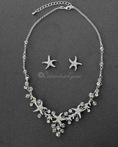 a necklace and earring set with starfishs on the side, in silver