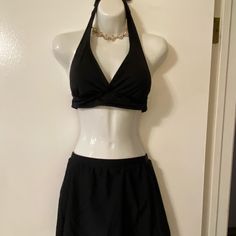 Black Halter Swim Top With Sewn In Pads By Catalina. Ties Around Neck And Back. Size M (8-10). Tried On But Never Worn In Water. Unbranded Black Swim Skirt - Never Worn. Elastic Waist Measures 12 1/2”. Full Coverage Lined Bottoms. Chic Black Tankini With Built-in Bra, Elegant Fitted Halter Top For Vacation, Black Swimwear With Built-in Bra For Spring, Elegant Stretch Halter Top For Pool, Elegant Halter Top For Poolside, Elegant Fitted Halter Top For Poolside, Black V-neck Summer Tankini, Chic Fitted Swim Dress For Beach Season, Elegant Black Triangle Top Swimwear