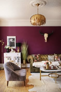 a living room with purple walls and furniture