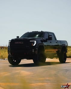 a black truck is parked on the road