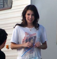 a woman standing next to a man in front of a trailer