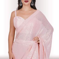 Are you ready to shine? Elevate your style with our Ready-Made Sequin Saree in the enchanting Blush shade. Crafted from high-quality georgette fabric adorned with mesmerizing sequin work, this saree promises a lavish and effortless style upgrade. It effortlessly drapes in less than a minute, ensuring you're ready to dazzle in no time! 🤩😍💃With its exquisite design and easy-to-wear nature, this Ready-Made Sequin Saree makes a statement without the need for elaborate draping or styling. The sequ Evening Georgette Sequin Fabric With Traditional Drape, Glamorous Evening Blouse Piece In Georgette, Glamorous Sequin Fabric For Wedding, Summer Party Pink Pre-draped Saree, Wedding Blouse With Sequins In Georgette, Pink Blouse With Traditional Drape For Party, Wedding Georgette Blouse With Sequins, Sequin Saree For Evening, Elegant Sequin Fabric In Traditional Drape For Parties