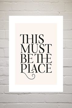 this must be the place print on a brick wall