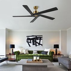 a living room filled with furniture and a ceiling fan in the middle of the room