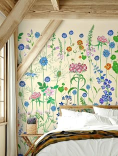 a bedroom with flowers painted on the wall