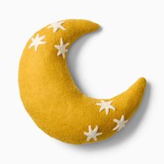 a yellow moon with white stars on it's side, against a white background