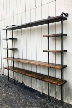 an industrial style shelving unit with three shelves on each side and one shelf attached to the wall