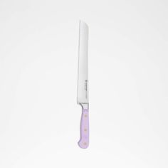 a white and purple knife on a white surface