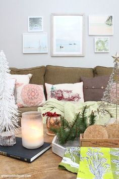 a living room filled with lots of furniture and christmas decorations on top of a wooden table