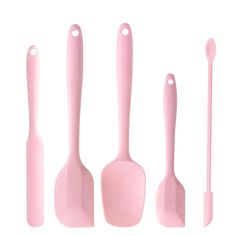 pink kitchen utensils and spoons are lined up against a white background,