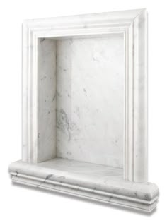 a white marble fireplace mantel with an ornate frame