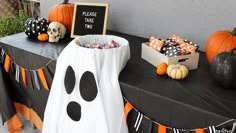 a table topped with candy and decorations for halloween