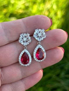 Cubic zirconia and ruby red crystal earrings!  perfect jewellery for weddings, special occasion. Custom colours available earrings are 1 inche or 2,5 cm long approx Red Crystal Earrings For Wedding, Red Round Bridal Earrings For Wedding, Formal Red Cubic Zirconia Earrings, Elegant Ruby Bridal Earrings For Wedding, Red Ruby Bridal Earrings, Silver Ruby Earrings For Wedding, Red Cubic Zirconia Bridal Earrings For Party, Red Ruby Wedding Earrings, Red Teardrop Crystal Earrings For Wedding