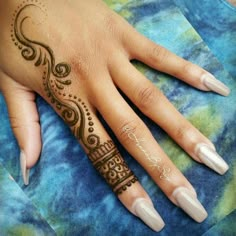 a woman's hand with henna tattoos on her left hand and the word love written