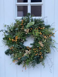 a wreath hanging on the side of a white door