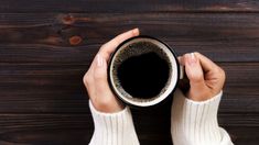 a woman holding a cup of coffee in her hands