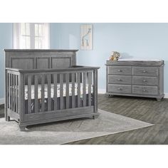 a baby crib with two dressers and a bed in the middle of it