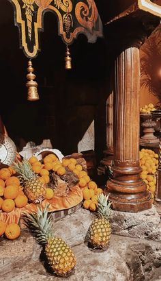 there are pineapples and oranges on the table