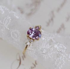 a close up of a ring with a purple stone