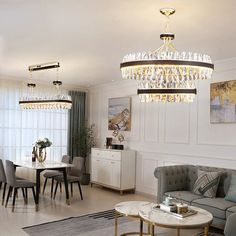 a living room filled with furniture and a chandelier hanging over the top of it