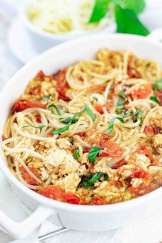 a white bowl filled with pasta and vegetables