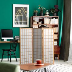 a room divider in front of a green wall