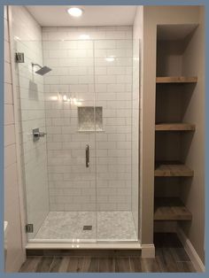 a walk in shower sitting inside of a bathroom