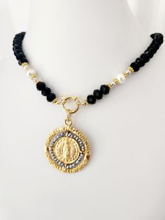 Virgin of Guadalupe Medal Necklace in Black Beaded Necklace - Religious Jewelry, Catholic Gifts, Women's Christmas Gift  This stunning Virgin of Guadalupe Medal Necklace, elegantly set on a black beaded necklace. Handcrafted with attention to detail, this unique piece combines glass beads and pearls to create a striking design that symbolizes devotion and grace. The medallion of the Virgen de Guadalupe shines as the centerpiece, making it perfect for those seeking both spiritual and fashion-forw Black Spiritual Necklace With Coin Pendant, Black Beaded Necklace, Catholic Necklace, Virgin Of Guadalupe, Mexican Jewelry, Black Bead Necklace, Catholic Gifts, Religious Jewelry, Christmas Gifts For Women