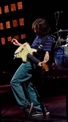 a man playing an electric guitar on stage