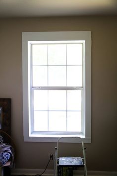 a ladder is in front of a window with the light coming through and on it