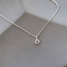 "READY TO SHIP! * Tiny diamond pendant measures approximately 1/4 inch long, including loop * Sterling Silver cable chain finished with lobster clasp and adjustable from 16\", 17\", 18\" and 18.5\" * Salt and pepper diamond, 3mm in diameter, .08 carats FULL DETAILS: A natural, round salt and pepper diamond is bezel-set in sterling silver and hangs from a loop on a delicate sterling silver cable chain and finished with a lobster clasp. The silver chain is adjustable and can be worn at 16, 17, 18, Carousel Necklace, Tiny Diamond Necklace, Pendant Choker, Enamel Necklaces, Tiny Diamond, Unique Diamonds, Gold Necklace Layered, Leaf Charms, Salt And Pepper Diamond