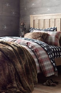 a bed sitting in a bedroom under a window next to a wooden headboard and foot board