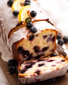 a loaf of lemon blueberry bread on a cutting board