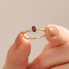 Elevate your love story with our 14k Solid Gold Minimalist Garnet Oval Ring, a symbol of elegance and timeless commitment. This flower engagement ring for women features a small red gemstone halo, adding a touch of romance to your style. Crafted in real gold, it's not just a piece of jewelry; it's a symbol of your unique love and sophistication, making it perfect for your special moment.    Ring Details  ❥ 14k Solid Gold(also in 10, 18K)  ❥ Gold Color Options; Yellow Gold, White Gold, Rose Gold Garnet Engagement Ring Gold, Garnet Birthstone Rings, Red Engagement Ring, Red Garnet Jewelry, Gold Garnet Ring, January Birthstone Jewelry, January Birthstone Rings, Garnet Engagement Ring, Flower Engagement