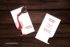 two business cards with red wine on them