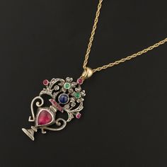 This remarkable giardinetti or "little garden" pendant from the Georgian or early Victorian era (circa 1820-1850)! This outstanding pendant features an urn of flowers adorned with colorful gemstones. The pendant was originally an antique silver brooch transformed with the addition of a 14k gold bail. The pendant holds rose cut diamonds, a teardrop shaped pink tourmaline, a high domed natural sapphire, and smaller green and pink glass accents. The pendant measures 1.6 inches from top to bottom by Sunburst Ring, Flower Urn, Colorful Gemstones, Urn Pendant, Little Garden, Silver Brooch, Natural Sapphire, Flower Basket, Pink Glass